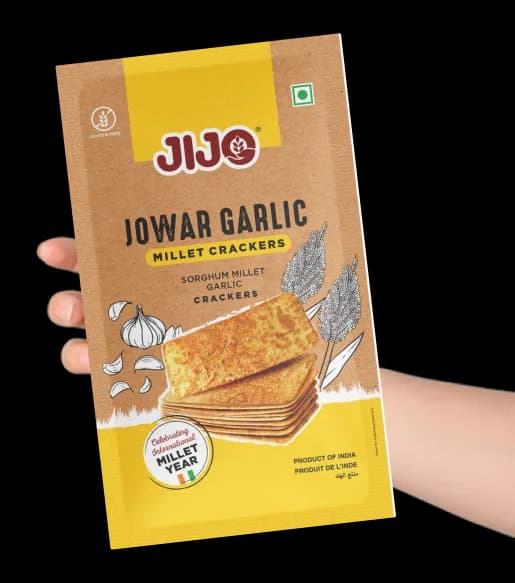 A pack of JIJO Millet Crackers held in a hand